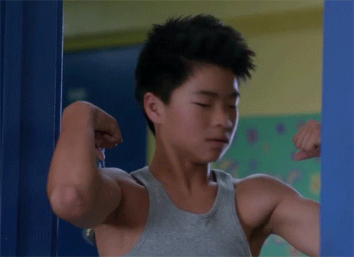 How to get stronger: boy kissing his biceps GIF